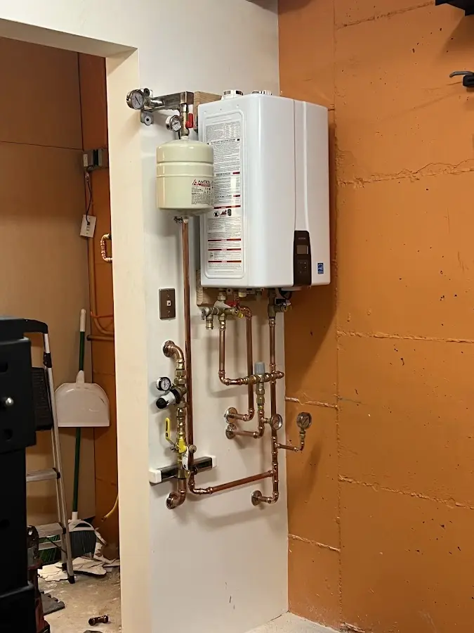 Plumbing technician inspecting water heater connections in Bridgewater